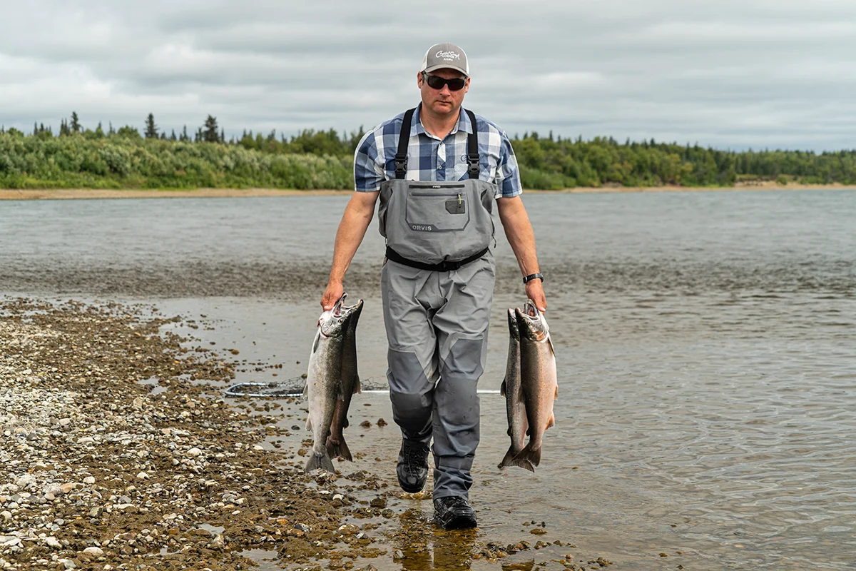 Alex walking back with a fresh catch of Silver Salmon