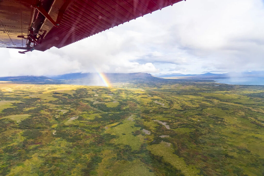View of a rainbow and wild Alaska from the window of a bush plane